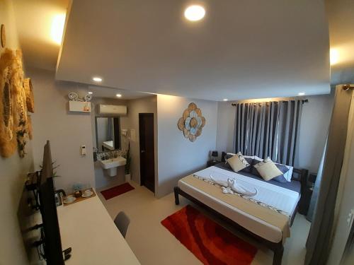 a small room with a bed and a bathroom at RC Villas and Resorts in El Nido