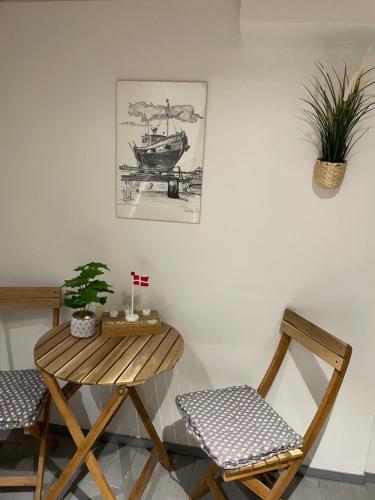 a room with two chairs and a table and a picture at Happy Fisherman BnB in Aalborg