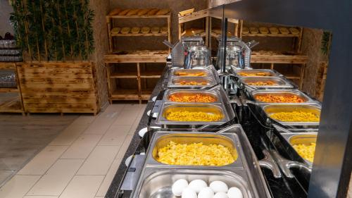 a buffet line with many trays of food at Gardan Hotel in Beylikduzu