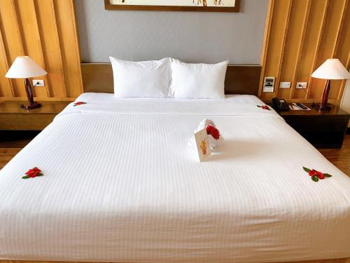 a hotel room with a bed with flowers on it at Muong Thanh Luxury Nhat Le Hotel in Dong Hoi