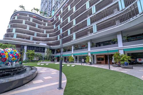 a large building with a lawn in front of a building at 10 min to My town family unit By Nexx Field in Kuala Lumpur
