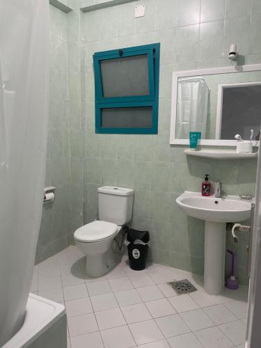 a bathroom with a toilet and a sink at A cozy room in 2 bedrooms apartment with a back yard in Sharm El Sheikh