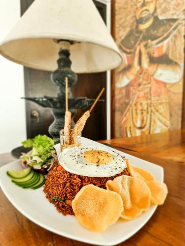 a plate of food with a sandwich on a table at Serendib Signature Resort in Digana