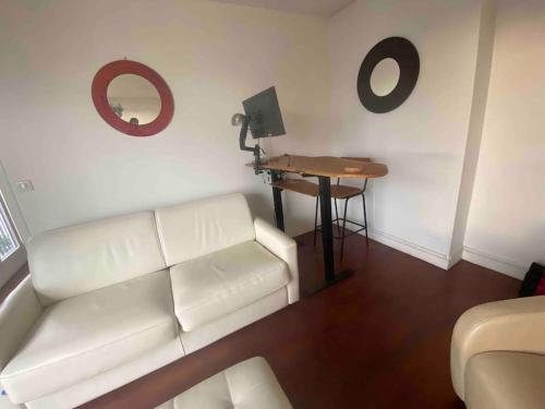 un salon avec un canapé blanc et une table dans l'établissement Eiffel Beaugrenelle - Beautiful T2 58m2 with Terrasse 22m2, à Paris
