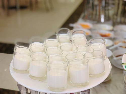 a tray of glasses of milk on a table at Muong Thanh Luxury Nhat Le Hotel in Dong Hoi