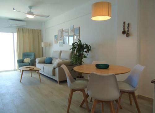 a living room with a table and a couch at Siente el mar in Villajoyosa