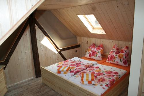 a small room with a bed in a attic at Ferienwohnung Nicklich in Berbisdorf