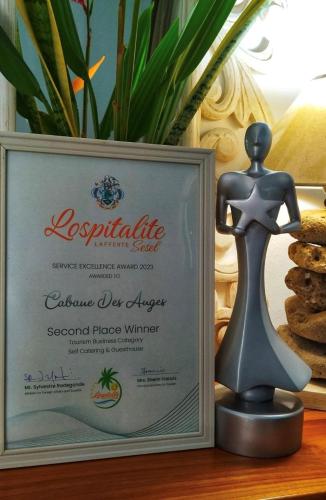 a picture of a mannequin in front of a certificate at Cabanes Des Anges in La Digue
