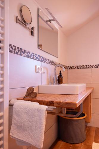 a bathroom with a sink and a mirror at Ferienwohnung Zum Wiesle in Krün