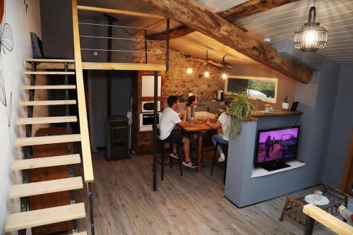 a couple sitting at a table in a tiny house at Domaine Ostau Montplaisant in Ponlat-Taillebourg