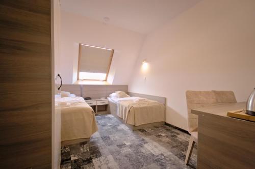 Ένα ή περισσότερα κρεβάτια σε δωμάτιο στο Hotel Sezam