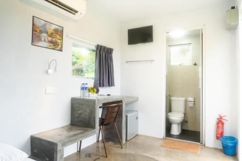 a bathroom with a sink and a toilet at Durian Ecolodge in Tampin