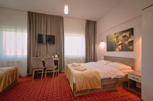 Ένα ή περισσότερα κρεβάτια σε δωμάτιο στο Hotel Sezam