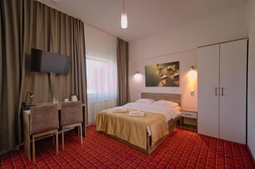 Ένα ή περισσότερα κρεβάτια σε δωμάτιο στο Hotel Sezam