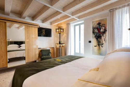 a hotel room with a bed and a bedroom at Spirito Santo Palazzo Storico in Rovinj