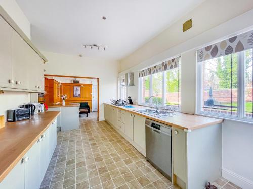 a large kitchen with white cabinets and a large window at *RG9bC* For your most relaxed & Cosy stay + Free Parking + Free Fast WiFi * in Moortown
