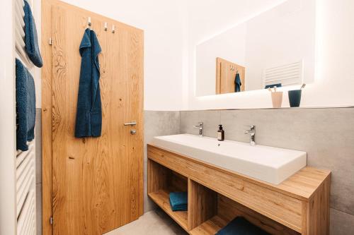 a bathroom with a white sink and a mirror at Ferienappartement Bergliebe in Grossarl