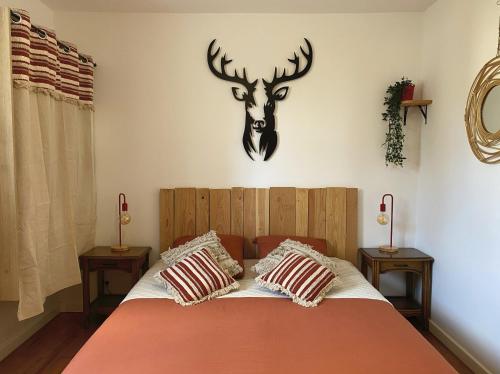 een slaapkamer met een bed met een hertenkop aan de muur bij Le Bourget, Grand appartement proche du centre in Grenoble