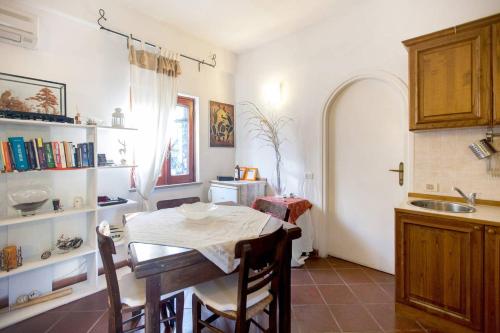 a kitchen with a table and chairs and a sink at Borgo Caere in Ladispoli