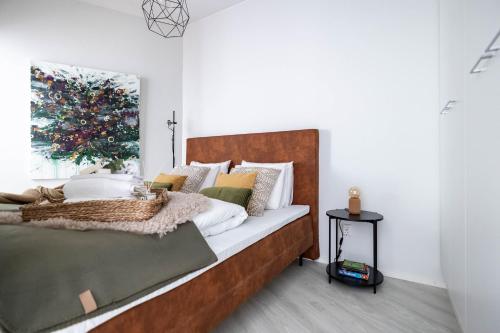 a bedroom with a large wooden bed with a window at Arctic Golden Sun City Suite in Rovaniemi