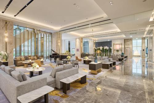 a lobby with couches and a grand piano at Grand HiLai Taipei in Taipei