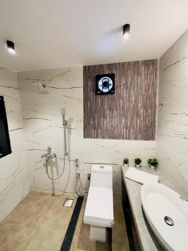 a bathroom with a sink and a toilet and a shower at CooCasa in Mahabaleshwar