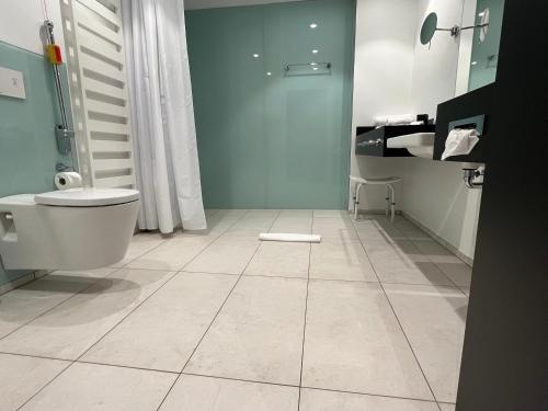 La salle de bains est pourvue de toilettes et d'un lavabo. dans l'établissement Hotel am Markt, à Wipperfürth