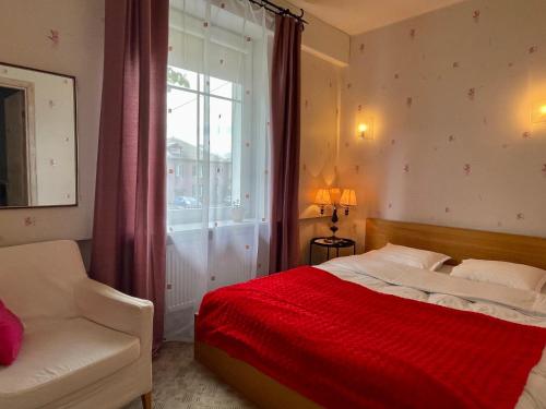 a bedroom with a red bed and a window at Lovely and quiet condo in Kristiine. Free parking. in Tallinn