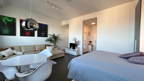a bedroom with a bed and a table and a couch at Skyview Studio Apartments at Berlin Kreuzberg-Mitte in Berlin