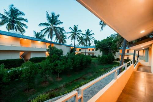a view from the balcony of a hotel with palm trees at Commune18 Resort Chikmagalur in Chikmagalūr