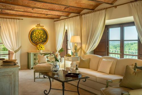 a living room with a couch and a table at Wine Resort Dievole in Vagliagli
