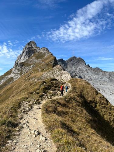 two people walking on a mountain trail at Chalet Müsli in Wildhaus