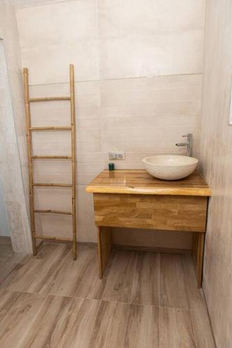 a bathroom with a sink on a wooden counter at Villa F4 chic avec jacuzzi en Martinique in Le Lamentin