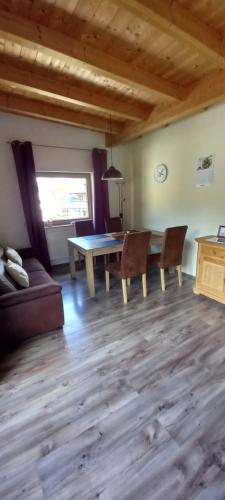 a living room with a table and chairs and a couch at Apartment Birgit in Uderns