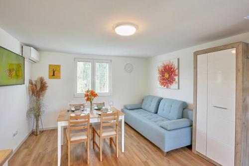 a living room with a blue couch and a table at Kuca za odmor Villavera in Donja Lomnica