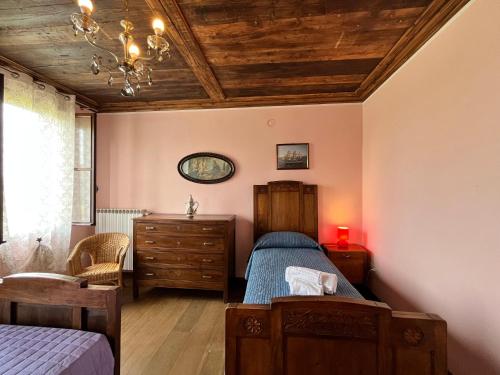 a bedroom with a bed and a wooden ceiling at Ca' De Franceschi in Teolo
