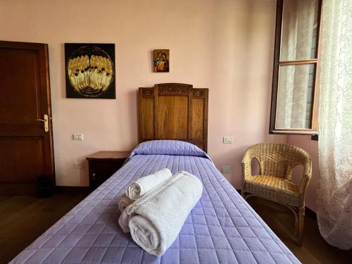 a bedroom with a bed with towels on it at Ca' De Franceschi in Teolo