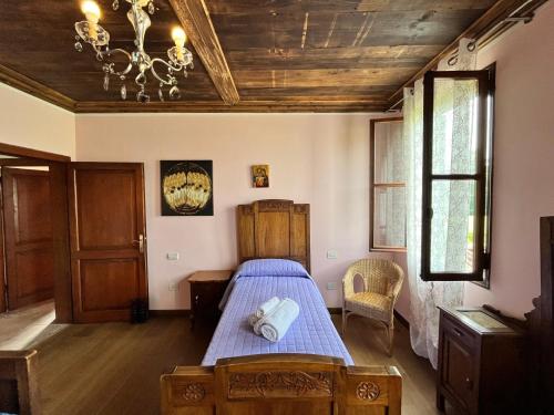 a bedroom with a bed with a blue comforter at Ca' De Franceschi in Teolo