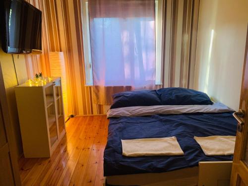 a small bedroom with a bed and a window at Peaceful Haven in Budapest