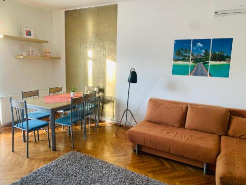 a living room with a table and a couch at Peaceful Haven in Budapest