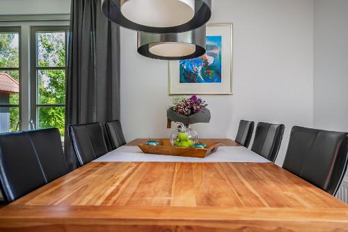 a dining room table with black chairs and a dining room at Appelhoeve in Appelscha
