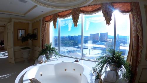 a bath tub in a room with a large window at Westgate in Las Vegas