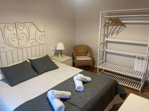 um quarto com uma cama com chinelos em Casa da Baltasara em Trives