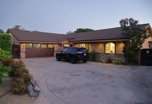 a car parked in front of a house at Cottage On The Greens - Studio in Poway