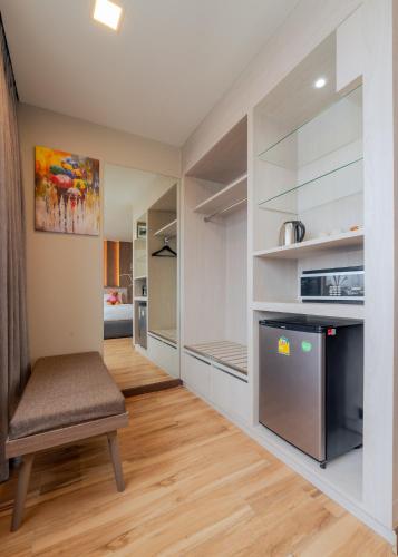 a kitchen with a bench and a refrigerator at Moose Hotel Chiangmai in Chiang Mai