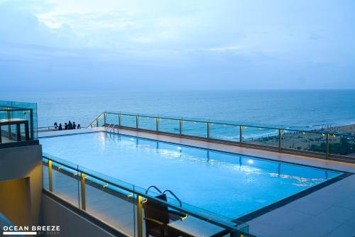 a large swimming pool on top of a building with the ocean at Ocean Breeze by DOXA in Negombo