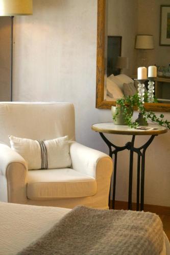 a living room with a couch and a table with a mirror at Hostal de la Plaça - Hotel Boutique in Cabrils