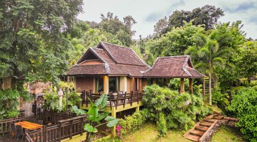 a house in the middle of a forest at Kanlaya's Eyrie, Luxury Homestay in Pang Mapha
