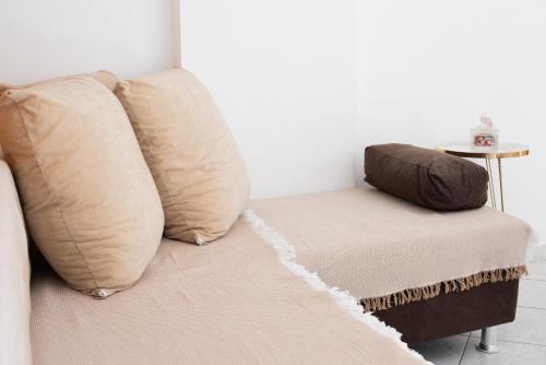 a couch with two pillows in a living room at GARDEN HOUSE, Kalamaki in Tympáki