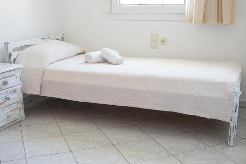a bed with two pillows on it in a room at GARDEN HOUSE, Kalamaki in Tympáki